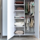 a closet with clothes and pillows
